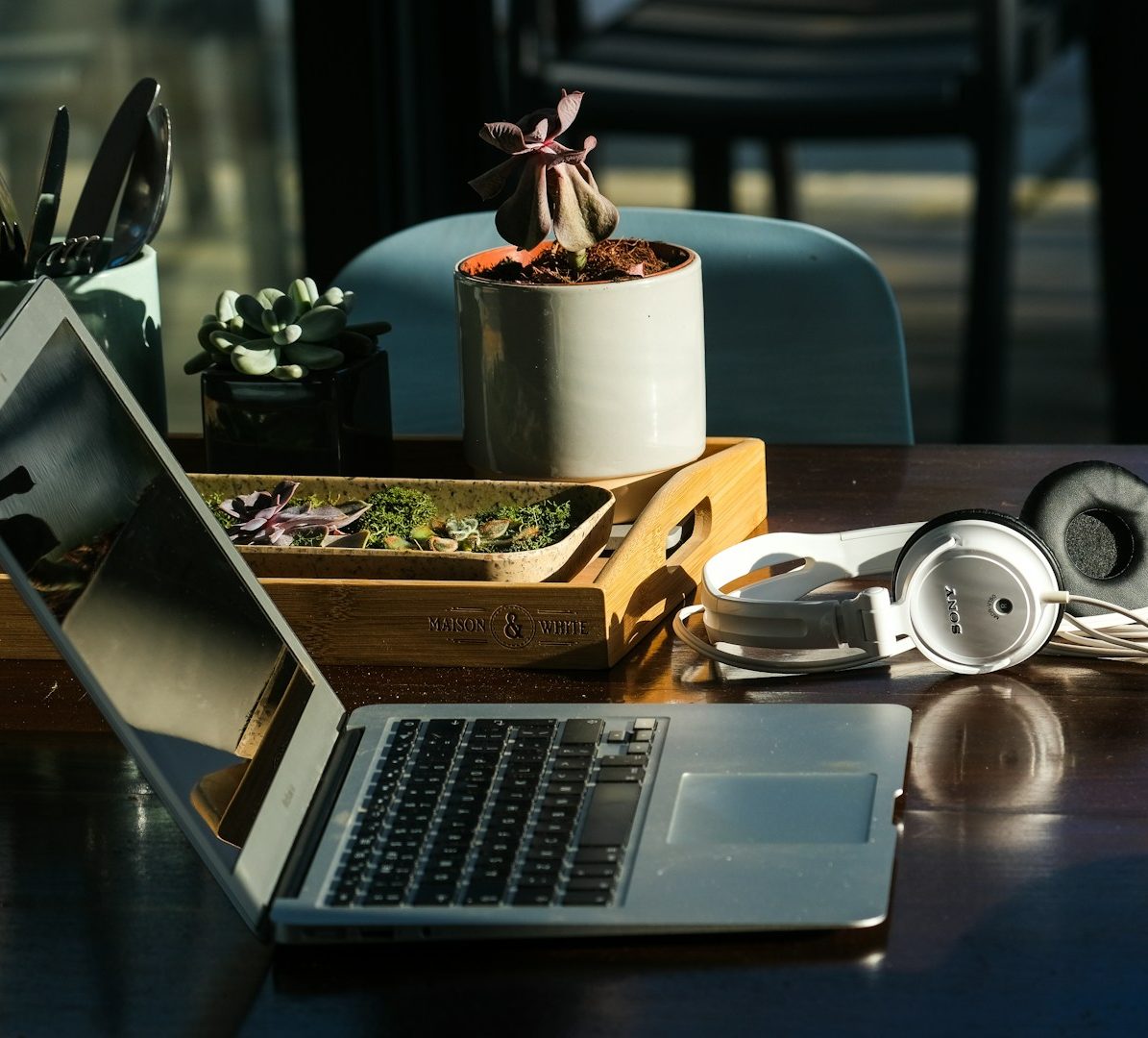 Laptop and headphones on a work desk.